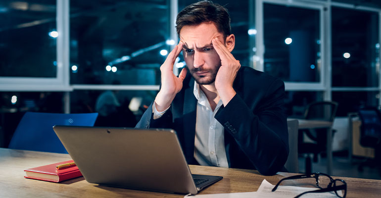 Gerente medio mostrando señales de burnout laboral en oficina
